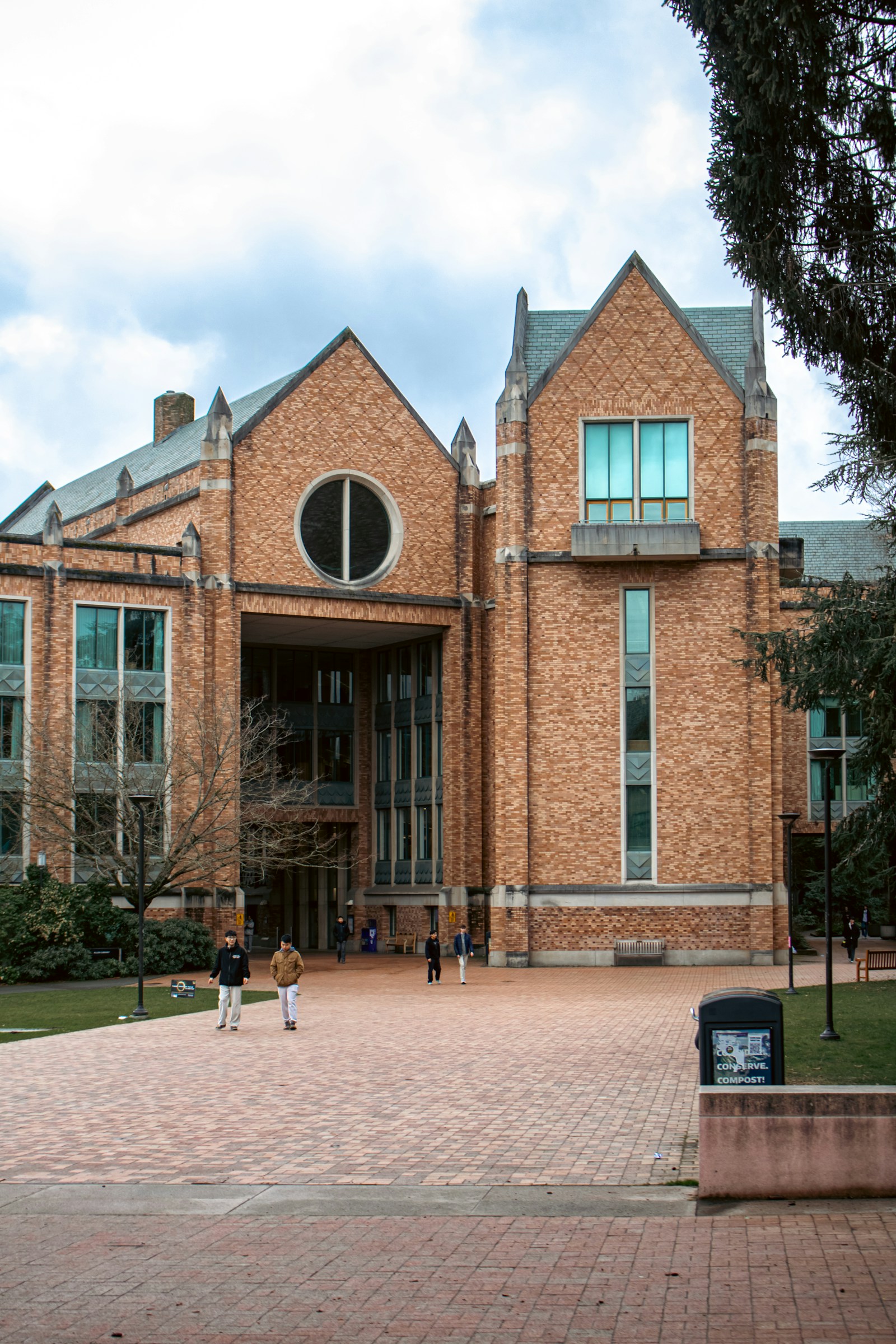 A university library building and students walking across campus