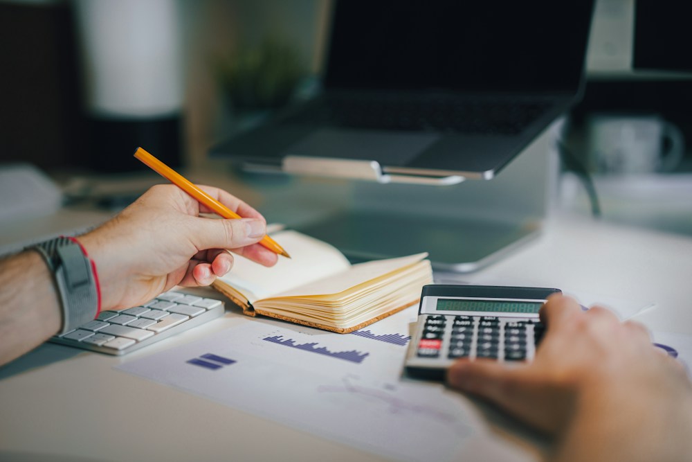Student reviewing business notes and calculations